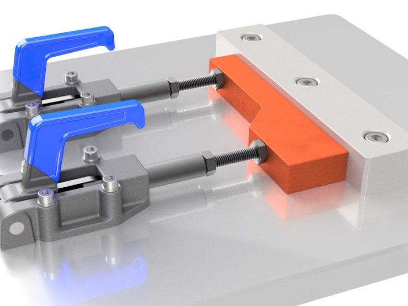 Two Sandfield Engineering toggle clamps holding a piece of material in place.